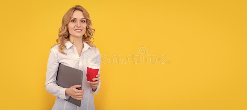 positive blonde woman with coffee cup and computer on yellow background. Horizontal poster design. Web banner header. royalty free stock photo