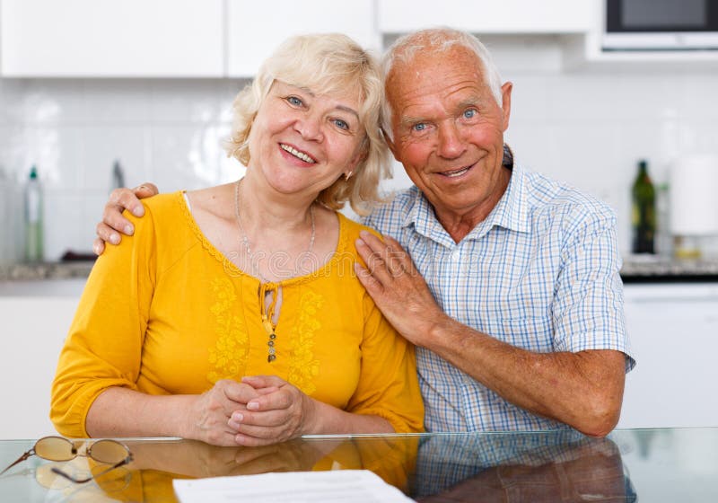 wood kitchen table and chair with elderly person sitting