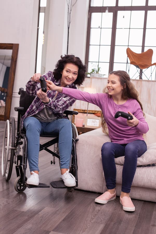 Positive Girl Helping Incapacitated Woman with Game Stock Image - Image ...