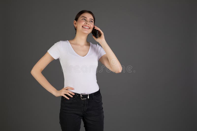 Positive happy beautiful girl with brunette hair in white t-shirt royalty free stock image Positive happy beautiful girl with brunette hair in white t-shirt royalty free stock image