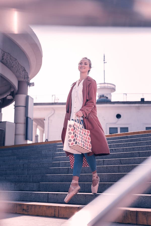 Positive nice woman going from the shop stock images Positive nice woman going from the shop stock images
