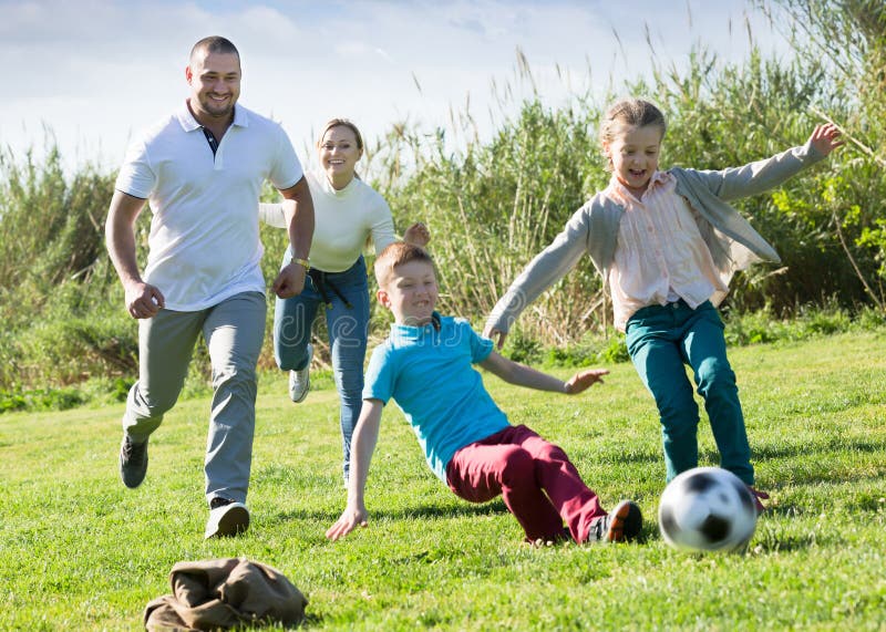 https://thumbs.dreamstime.com/b/positive-parents-two-kids-playing-soccer-positive-parents-two-kids-playing-soccer-green-field-focus-woman-236235372.jpg