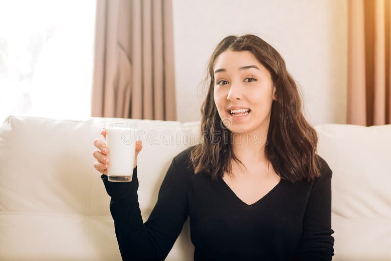 Beautiful young woman with glass of milk at home royalty free stock photo Beautiful young woman with glass of milk at home royalty free stock photo