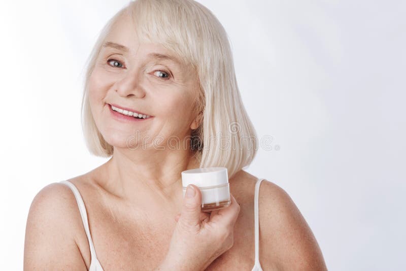 Positive senior woman fighting with wrinkles royalty free stock images Positive senior woman fighting with wrinkles royalty free stock images
