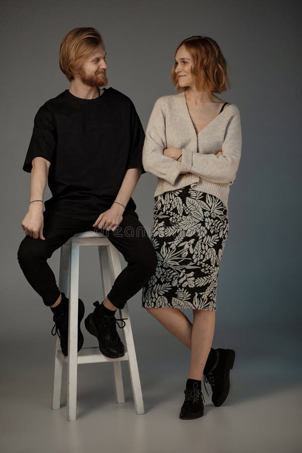 Positive smiling couple looking at each other posing in the studio royalty free stock images