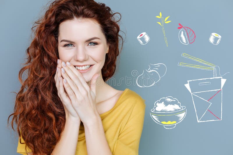 Positive student smiling while seeing unusual food in the restaurant