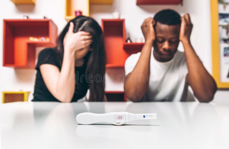 Positive test, pregnancy. Disappointment couple.