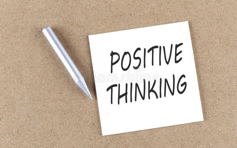 POSITIVE THINKING text on sticky note on a cork board with pencil