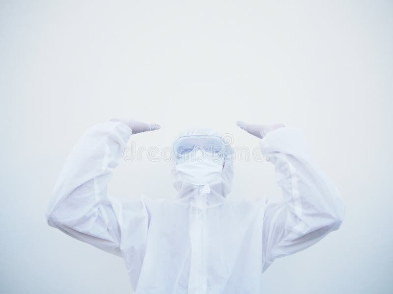 Positive young doctor or scientist in PPE suite uniform raising both hands to empty space above. coronavirus or COVID-19 concept stock image