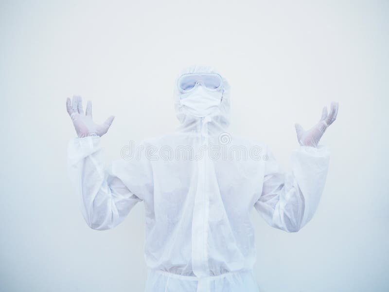 Positive young doctor or scientist in PPE suite uniform raising both hands to empty space above. coronavirus or COVID-19 concept stock photography