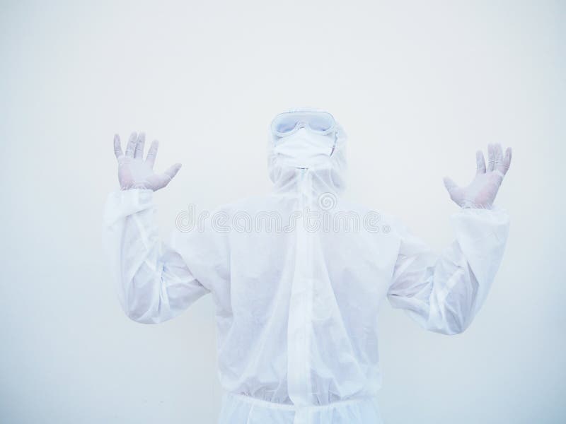 Positive young doctor or scientist in PPE suite uniform raising both hands to empty space above. coronavirus or COVID-19 concept stock images