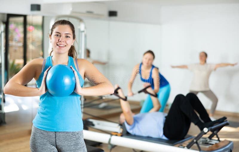 Pilates softball the teaser group exercise at fitness gym Stock Photo -  Alamy