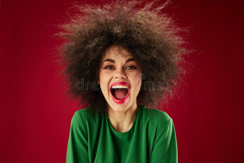 Positive young woman with curly hair grimace posing emotion studio model unaltered