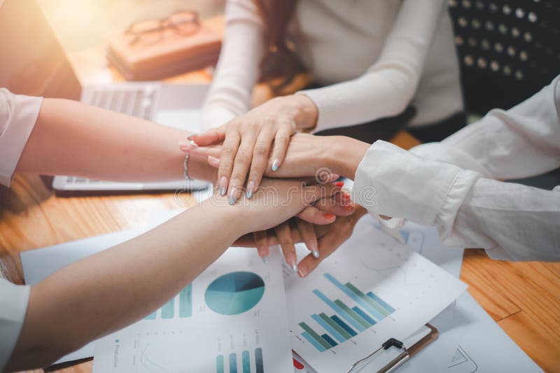 Positives und vielfältiges Geschäftsteam, das sich übereinander setzt lizenzfreies stockbild