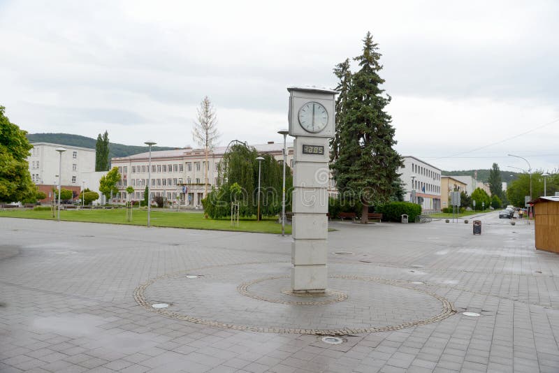 The post concrete clock in the small town stock photos