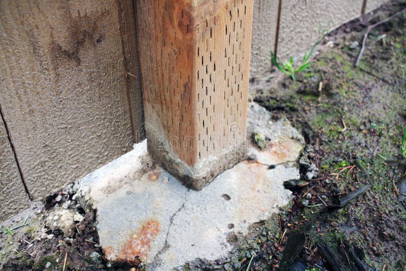 Post that Will Hold Up a Fence Showing it Sunk into Concrete Stock
