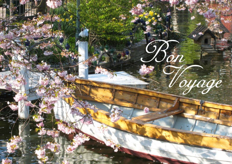 Postcard with a beautifully view of a wooden boat surrounded by a romantic sea of ​​flowers in a small lake - in Tivoli in Copenhagen in Denmark - postcard size format with a romantic script Text: Bon Voyage. Postcard with a beautifully view of a wooden boat surrounded by a romantic sea of ​​flowers in a small lake - in Tivoli in Copenhagen in Denmark - postcard size format with a romantic script Text: Bon Voyage