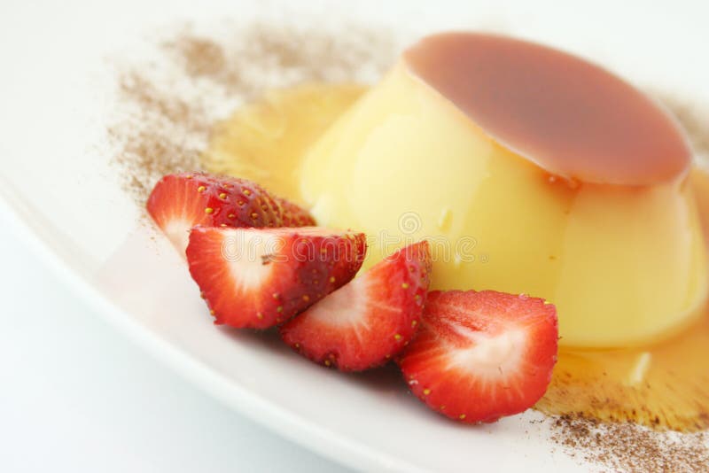 Close-up of a vanilla cream and caramel dessert with strawberries and mocha chocolate dressing. Sometimes called Creme Caramel. Close-up of a vanilla cream and caramel dessert with strawberries and mocha chocolate dressing. Sometimes called Creme Caramel.