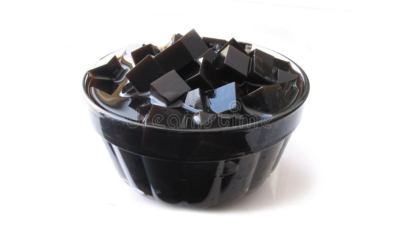 Photo image grass jelly with white background. The jelly itself is fragrant, with a smoky undertone and is a translucent dark brown, sometimes perceived to be black. Photo image grass jelly with white background. The jelly itself is fragrant, with a smoky undertone and is a translucent dark brown, sometimes perceived to be black.