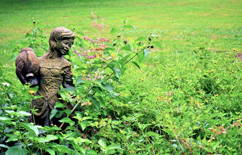 Girl statue in a garden. Girl statue in a garden