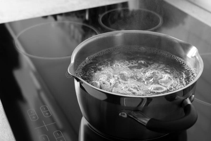 Pot with boiling water on electric stove