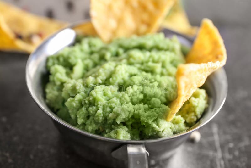 Pot with delicious guacamole and nachos, closeup royalty free stock image