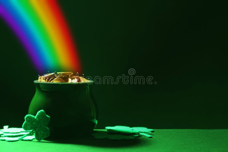 Pot with gold coins and clover leaves on table, space for text. St. Patrick`s Day celebration