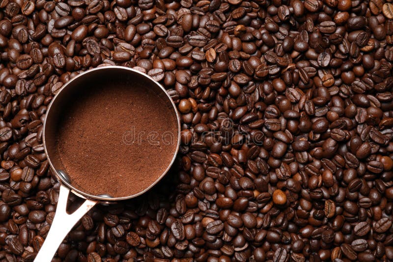 Pot with Ground Coffee on Roasted Beans, Top View. Space for Text Stock
