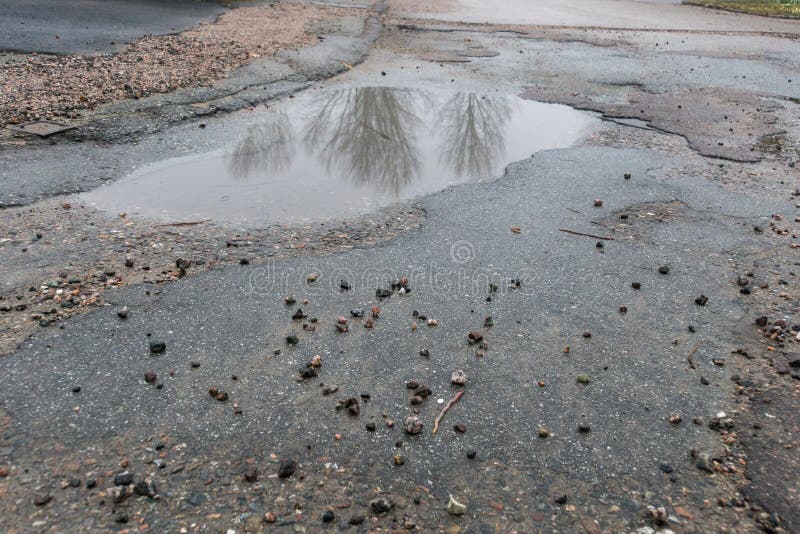 Pot holes with water in road royalty free stock photo