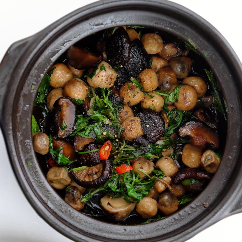 Pot Vietnamese vegan dish, straw mushroom, agaric cook with sauce and chili, pepper stock photos