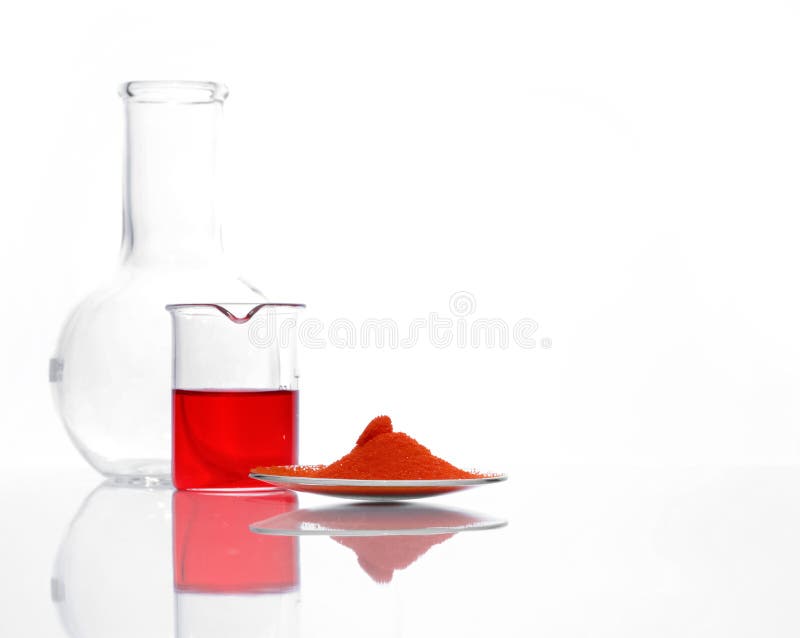 Potassium Dichromate in chemical watch glass place next to Potassium Ferricyanide liquid in beaker and Flat Bottom Flask