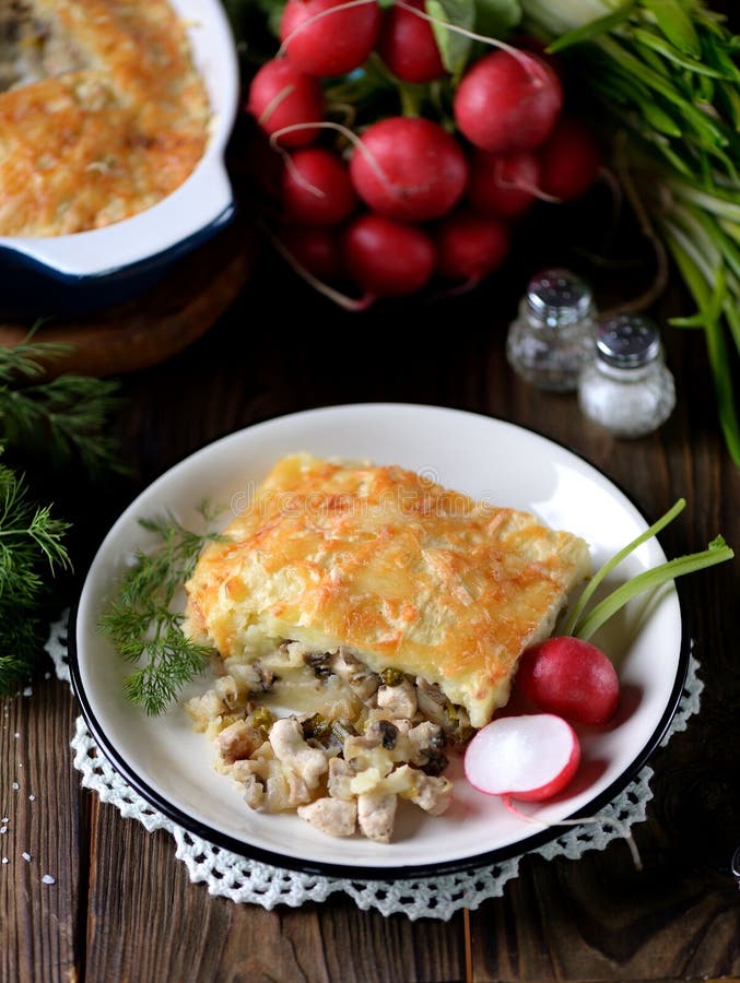 Potato casserole with chicken breast, mushrooms, onion and cheese.