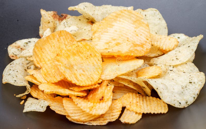 Potato chip on black dish stock photo. Image of delicious 34924468