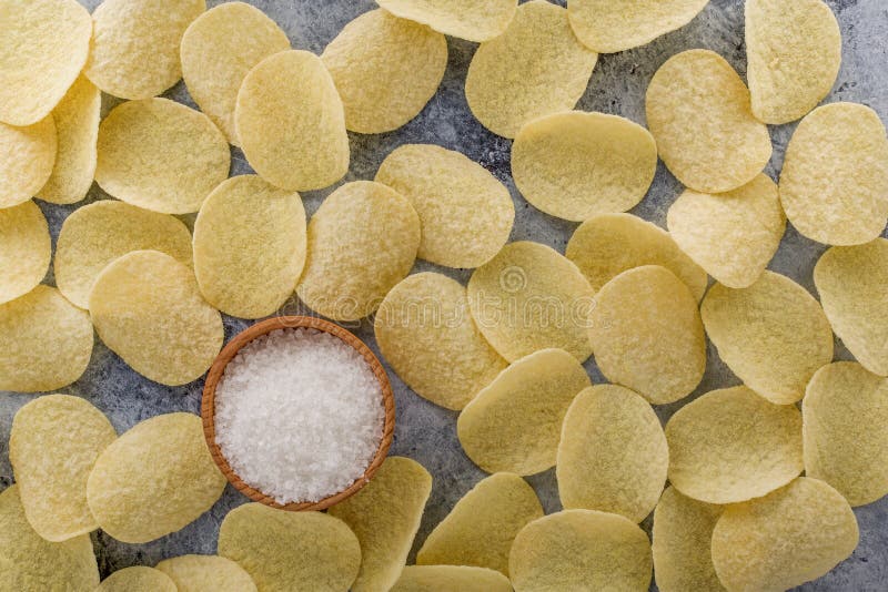 Potato chips on grey concrete table. Concept of fast food and snacks royalty free stock images Potato chips on grey concrete table. Concept of fast food and snacks royalty free stock images