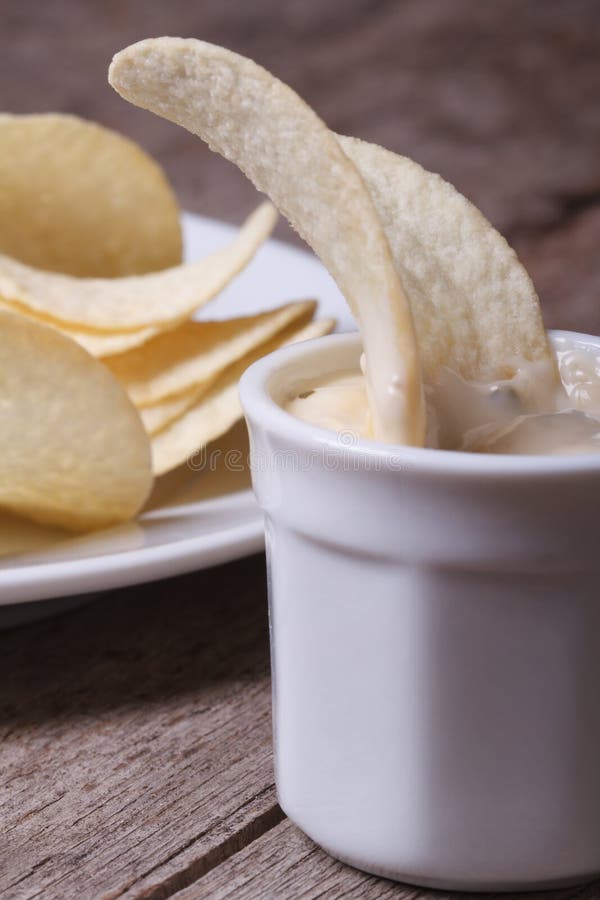 Potato Chips in a White Sauce Macro. Vertical Stock Photo Image of