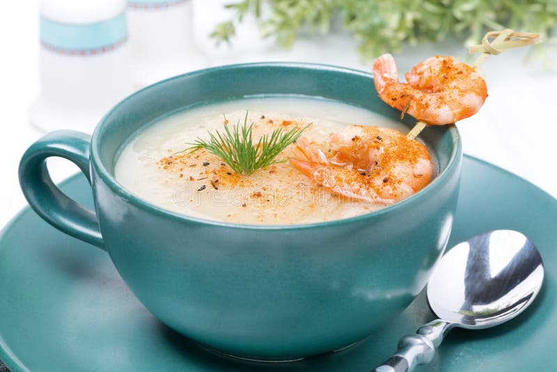 Potato cream soup with shrimps on a skewer, close-up