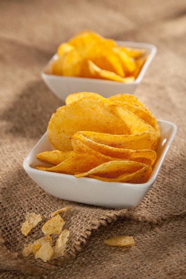 Potato crisps in two white bowls