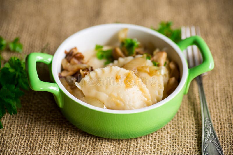 Potato Dumplings with Onion and Mushrooms in a Plate. Stock Photo