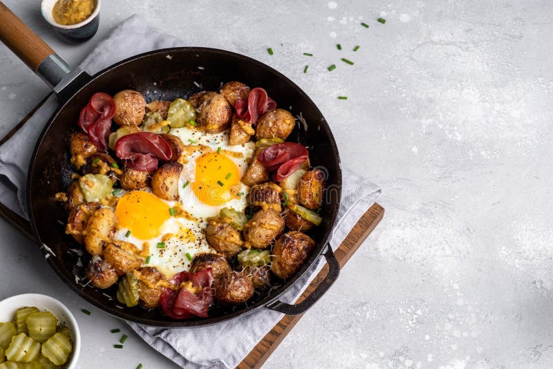 Potato Hash with Fried Eggs and Meat Pastrami for Breakfast Branch