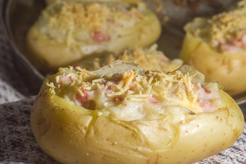 Potato Stuffed with Cheese, Sausage and Ham and a Table Cloth in the