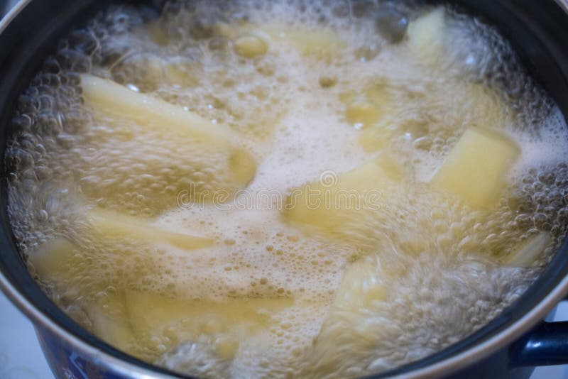 Potatoes are Being Cooked in Boiling Water in a Cooking Pot. Stock