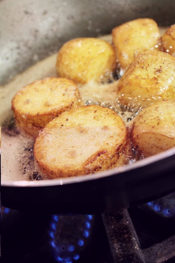 Potatoes cooking in pan stock image. Image of making 61845995