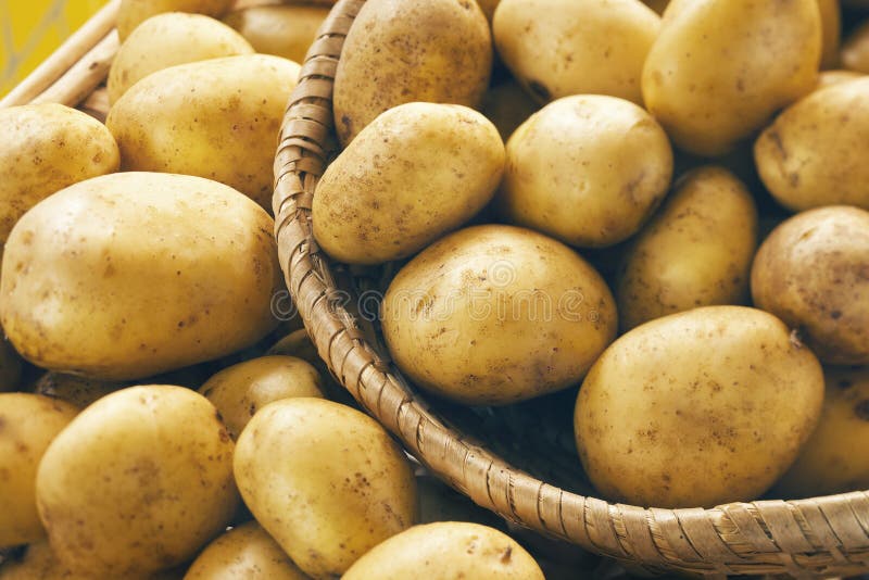 Potatoes. Fresh potatoes on wooden basket royalty free stock photography