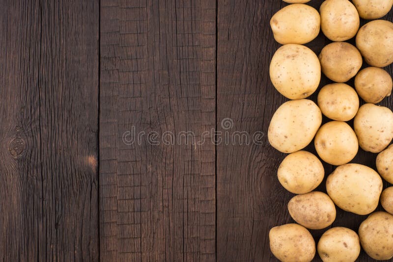 Potatoes on rustic wooden background. stock images Potatoes on rustic wooden background. stock images