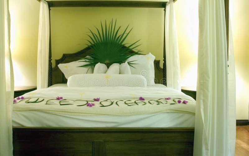 frette high thread count sheets on King size four post bed in the luxury prime minister suite set for guests at sleeptime with the words sweet dreams in palm fronds leaves leaf Sandals Grande Resort with with a horizontal top rail in st. st Lucia in the West Indies at Rodney Bay and Gros Islet eastern caribbean in the beautiful caribbean sea it is one windward islands first found by european explorers in 1500 and now independent. frette high thread count sheets on King size four post bed in the luxury prime minister suite set for guests at sleeptime with the words sweet dreams in palm fronds leaves leaf Sandals Grande Resort with with a horizontal top rail in st. st Lucia in the West Indies at Rodney Bay and Gros Islet eastern caribbean in the beautiful caribbean sea it is one windward islands first found by european explorers in 1500 and now independent