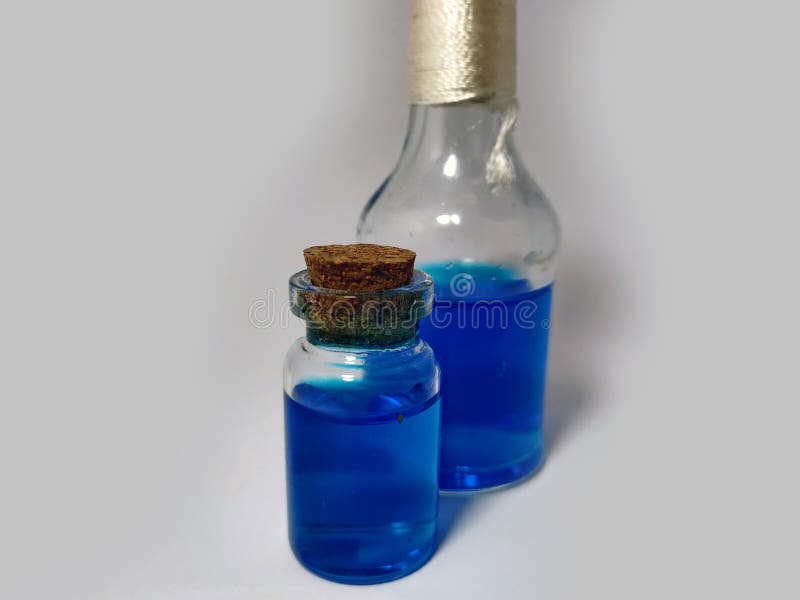 Potions with blue liquid mana. Alchemy set with flasks. small glass bottles with colored liquid for game role play. magic potions stock photography