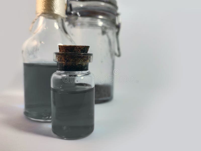 Potions with gray liquid. Alchemy set with flasks. small glass bottles with colored liquid for game role play. magic potions with royalty free stock images