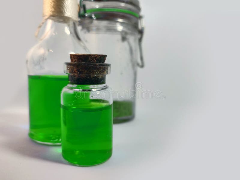 Potions with green liquid. Alchemy set with flasks. small glass bottles with colored liquid for game role play. magic potions with royalty free stock photos