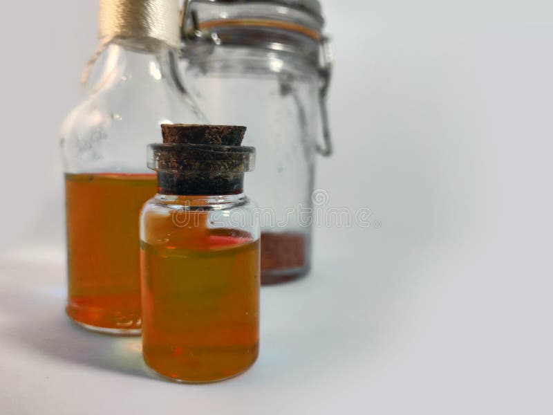Potions with orange liquid. Alchemy set with flasks. small glass bottles with colored liquid for game role play. magic potions royalty free stock image