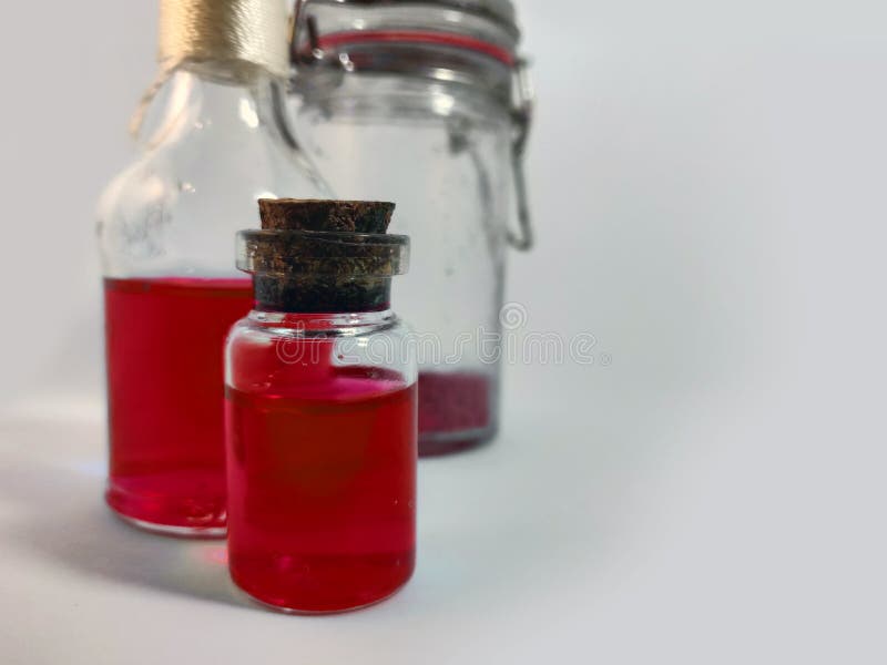 Potions with red liquid. Alchemy set with flasks. small glass bottles with colored liquid for game role play. magic potions with stock photography
